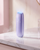 LUMORA Glow Pro IPL device with sapphire cooling light on a marble countertop