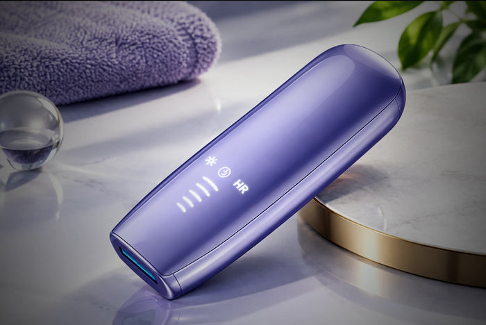 LUMORA Glow Pro — sapphire-cooling IPL hair removal device on a marble countertop